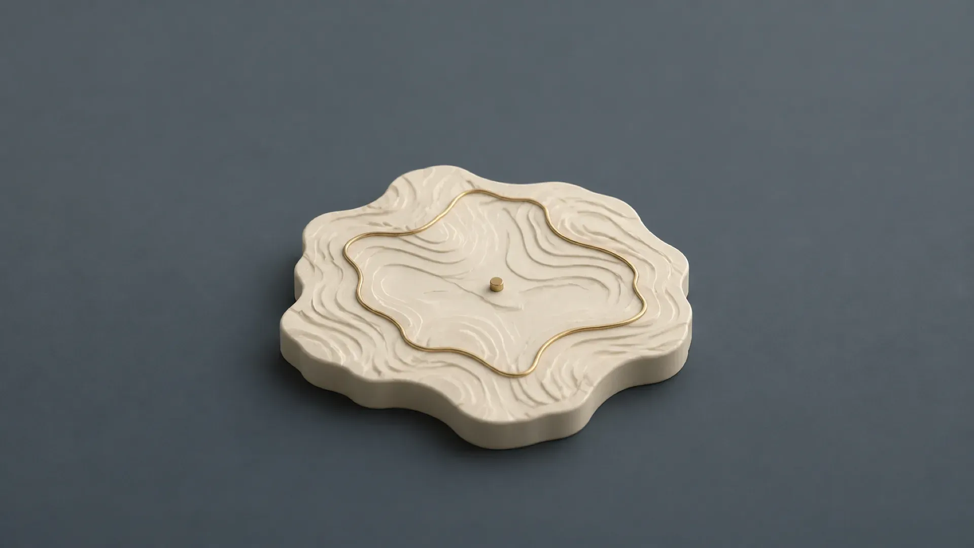 Illustration of a raised cream ceramic territory map tile with a brass boundary loop on a muted blue-gray background.